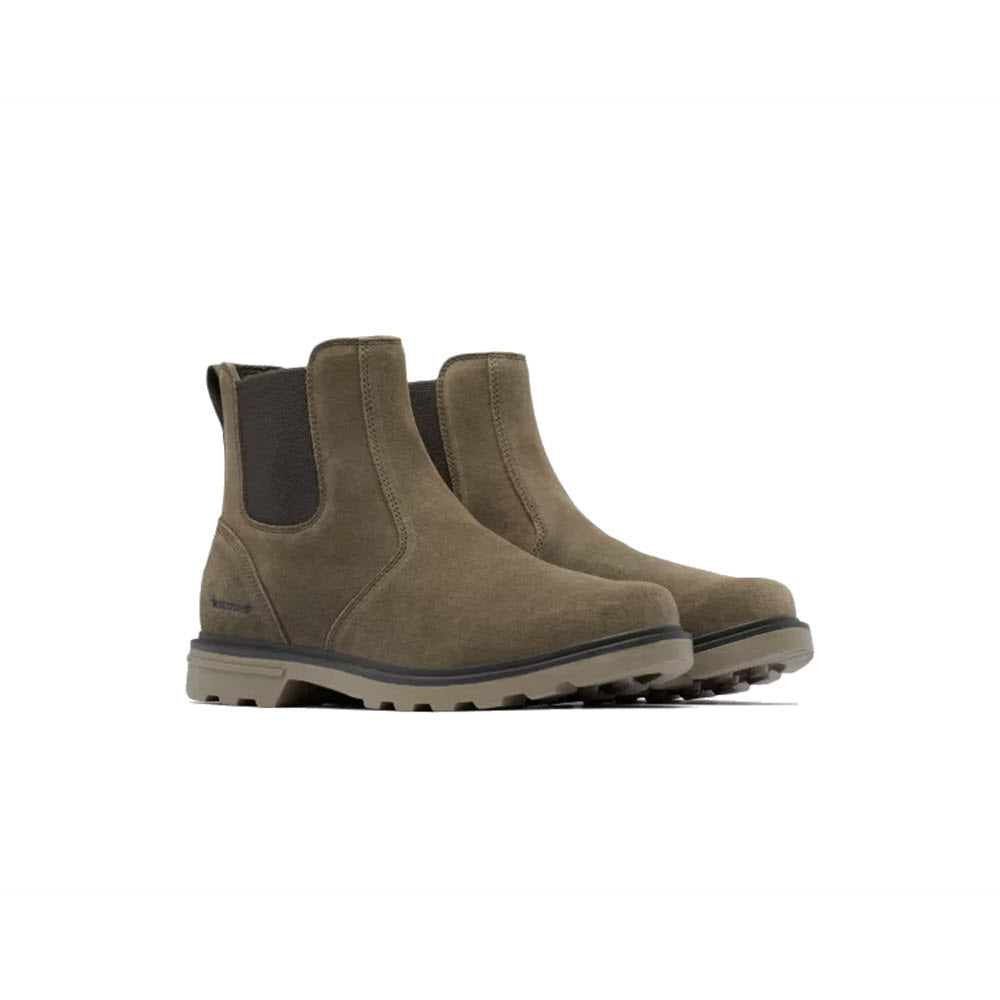 A pair of beige waterproof suede Sorel Carson Chelsea Boot Slip On with elastic side panels and a molded rubber sole, displayed on a white background.