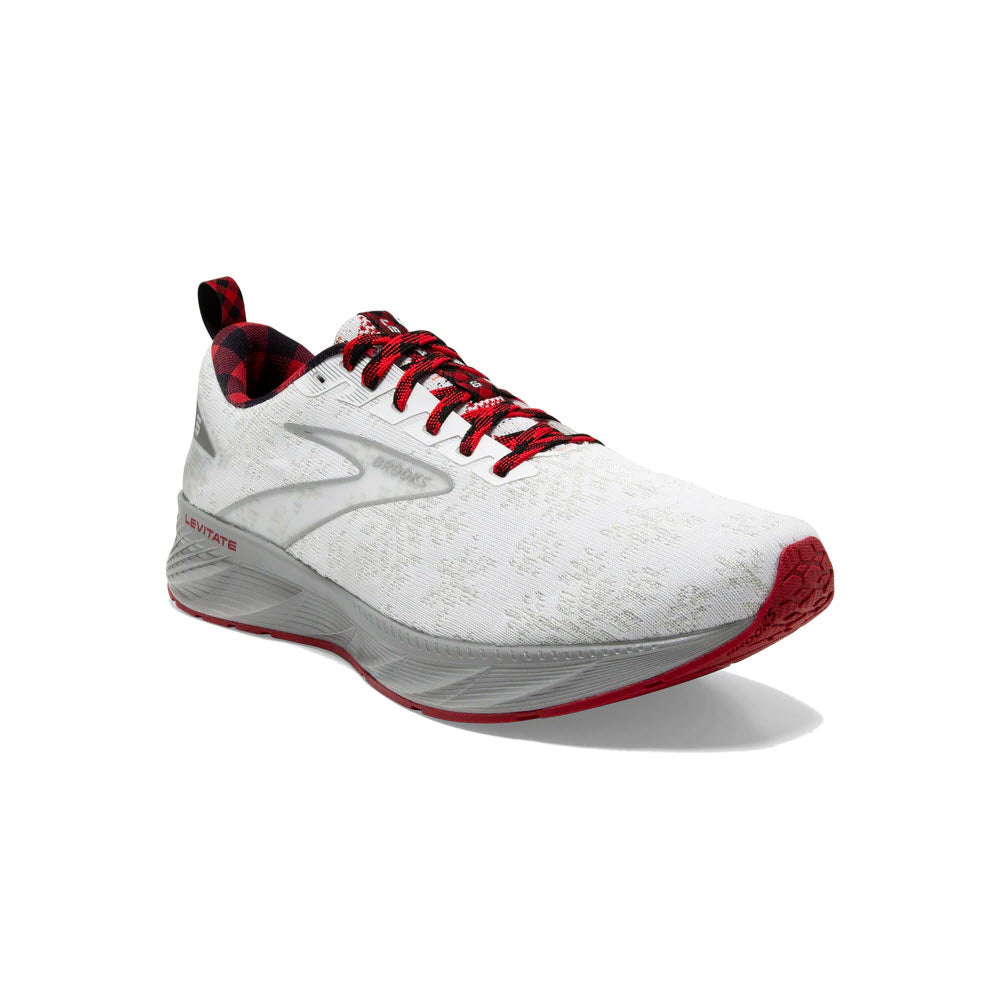 A Brooks Levitate 6 Christmas white and red running shoe with engineered creel mesh and a plaid interior, displayed against a white background.