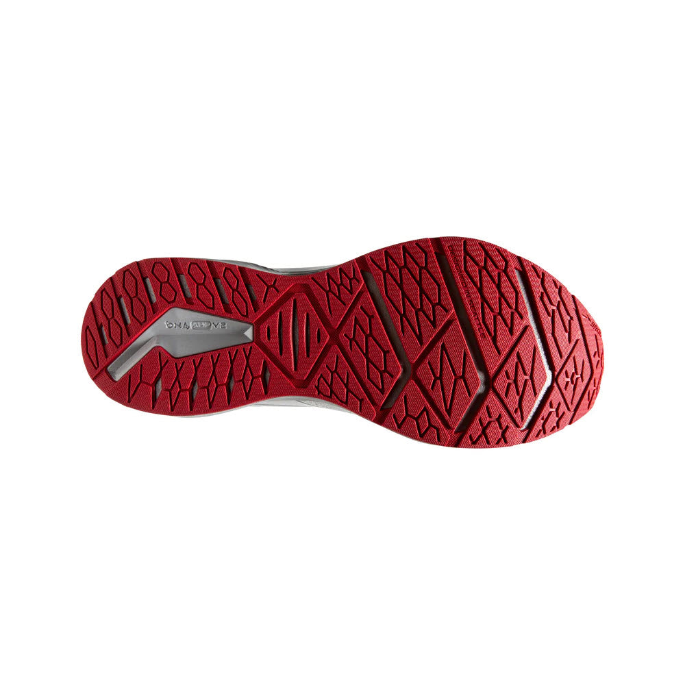 Red Brooks shoe sole with arrow-point outsole and size label, isolated on a white background.