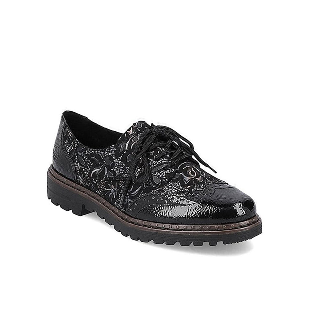 Black patent leather Rieker MODERN TAILORED BROGUE BLACK META brogues with floral embossed design and black laces, featuring anti-stress leather insoles, on a white background.