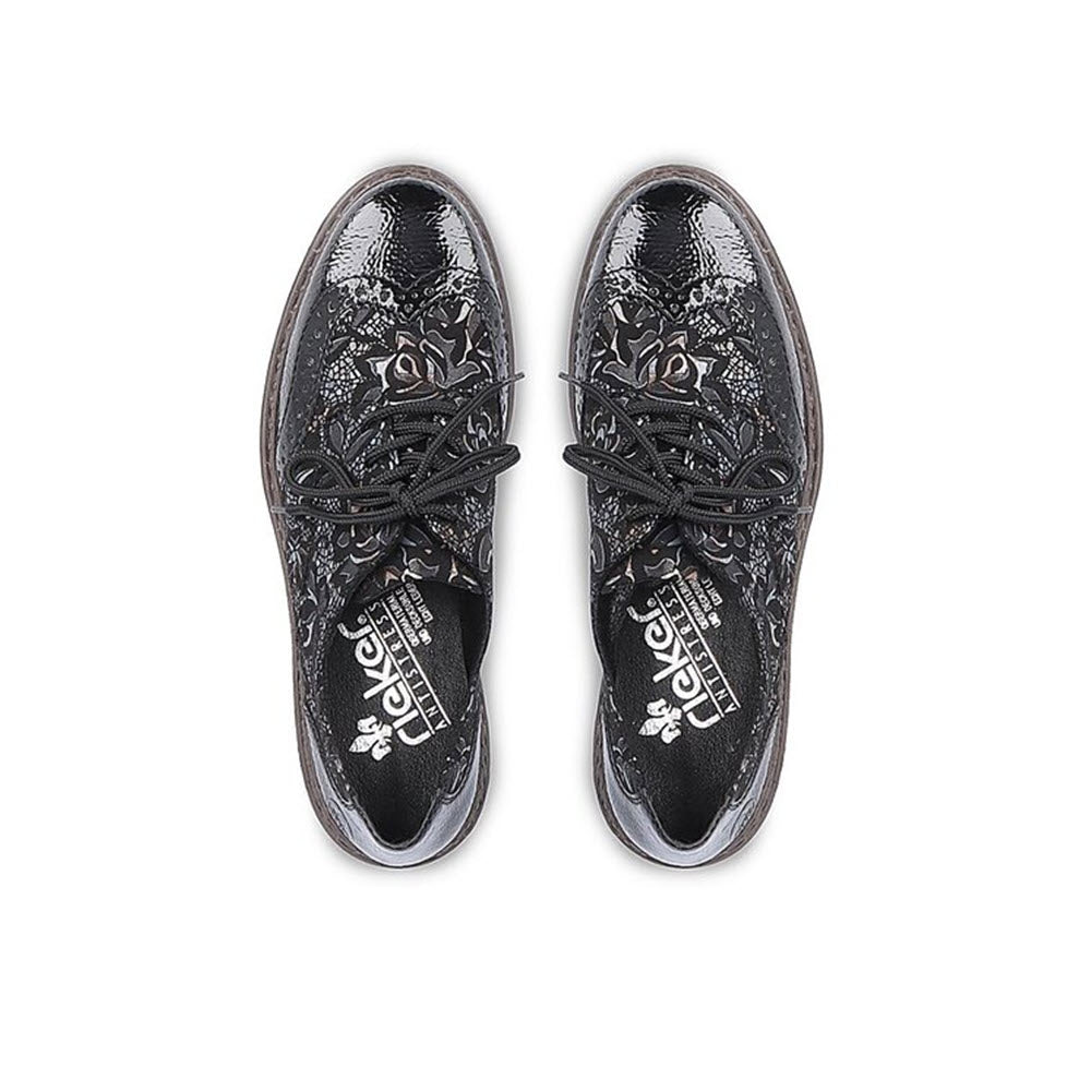 A pair of black Rieker Modern Tailored Brogues with a floral pattern on a white background.