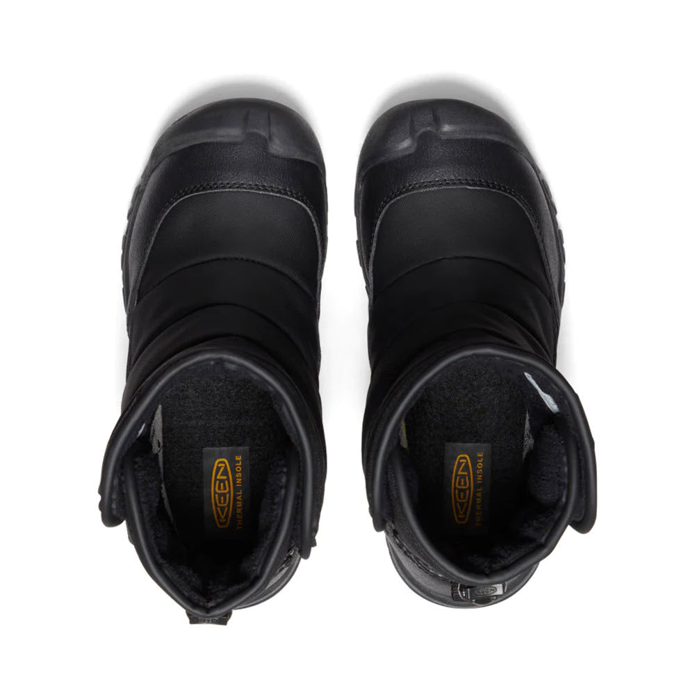 A pair of Keen PuffRider Black kids&#39; snow boots viewed from above, displaying the Keen logo inside.