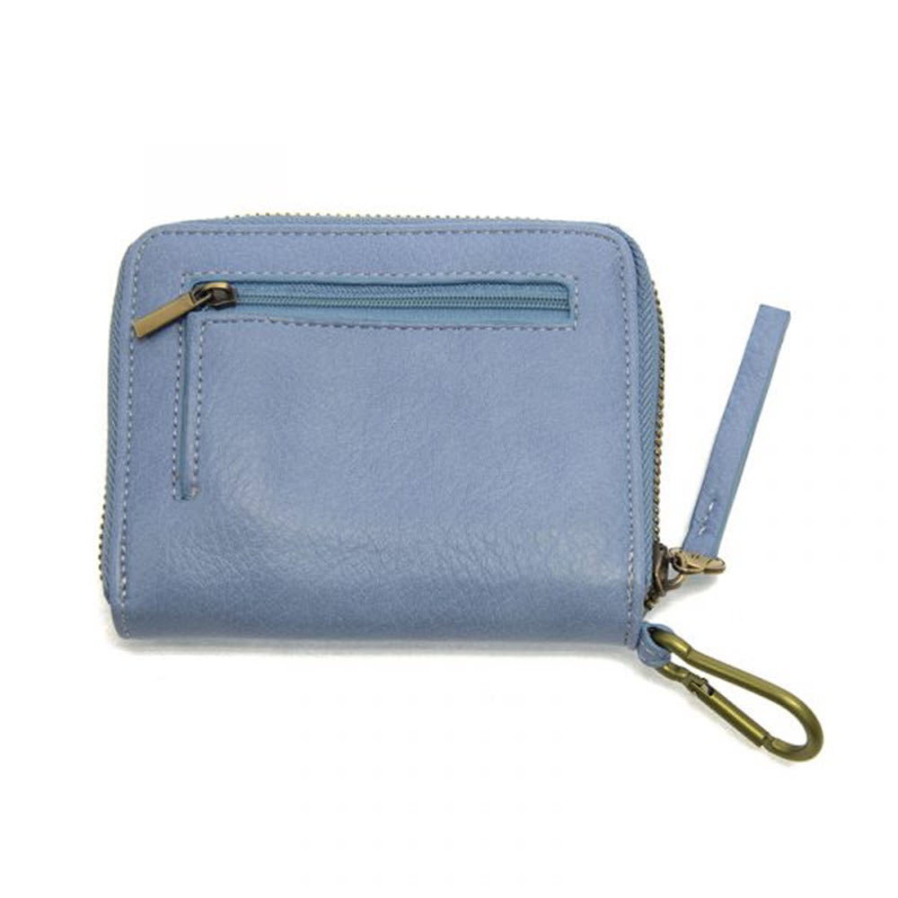 A JOY SUSAN PIXIE MINI GO WALLET SKY BLUE with a zip closure and external pocket, featuring a wrist strap and carabiner clip, isolated on a white background.