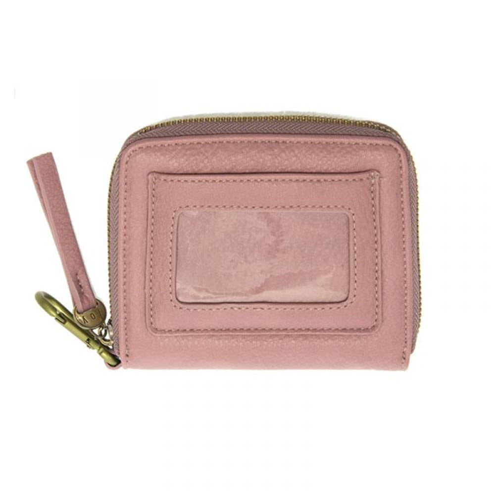 A light pink Joy Susan Pixie Mini Go wallet with a wrist strap and a gold zipper, featuring a clear ID window on one side.