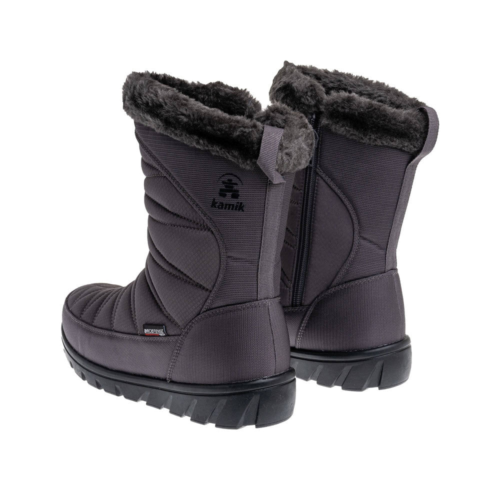 A pair of insulated Kamik snow boots in black with plush lining and side zippers, featuring waterproof construction, designed for cold weather.
