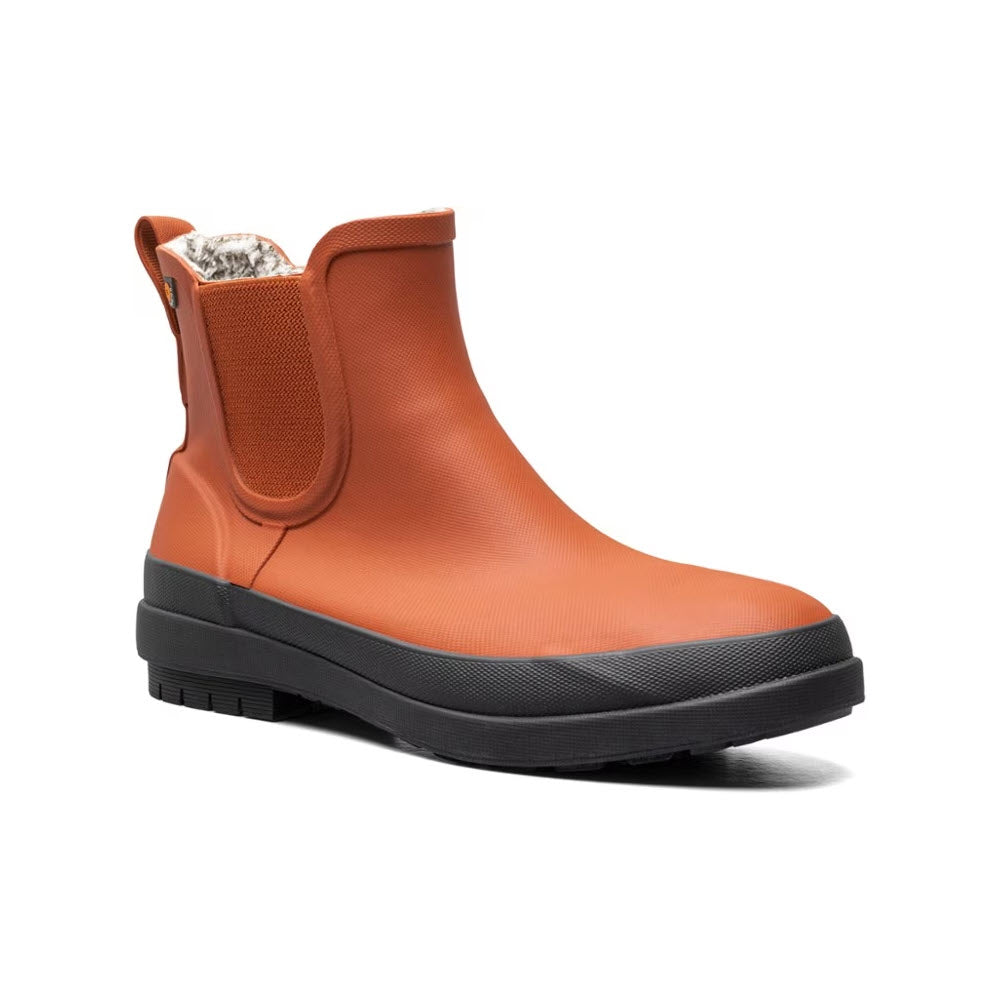 Waterproof Bogs Amanda Plush II Chelsea Burnt Orange boot with black sole and aluminum foil-like inner lining, isolated on a white background.