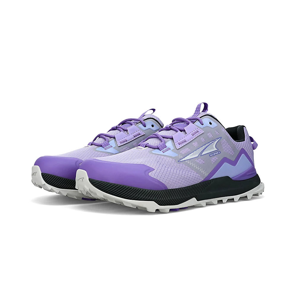 A pair of Altra Lone Peak All-Wthr Low 2 Gray/Purple trail running shoes with zig-zag designs featuring a MaxTrac™ outsole, and white soles on a white background.