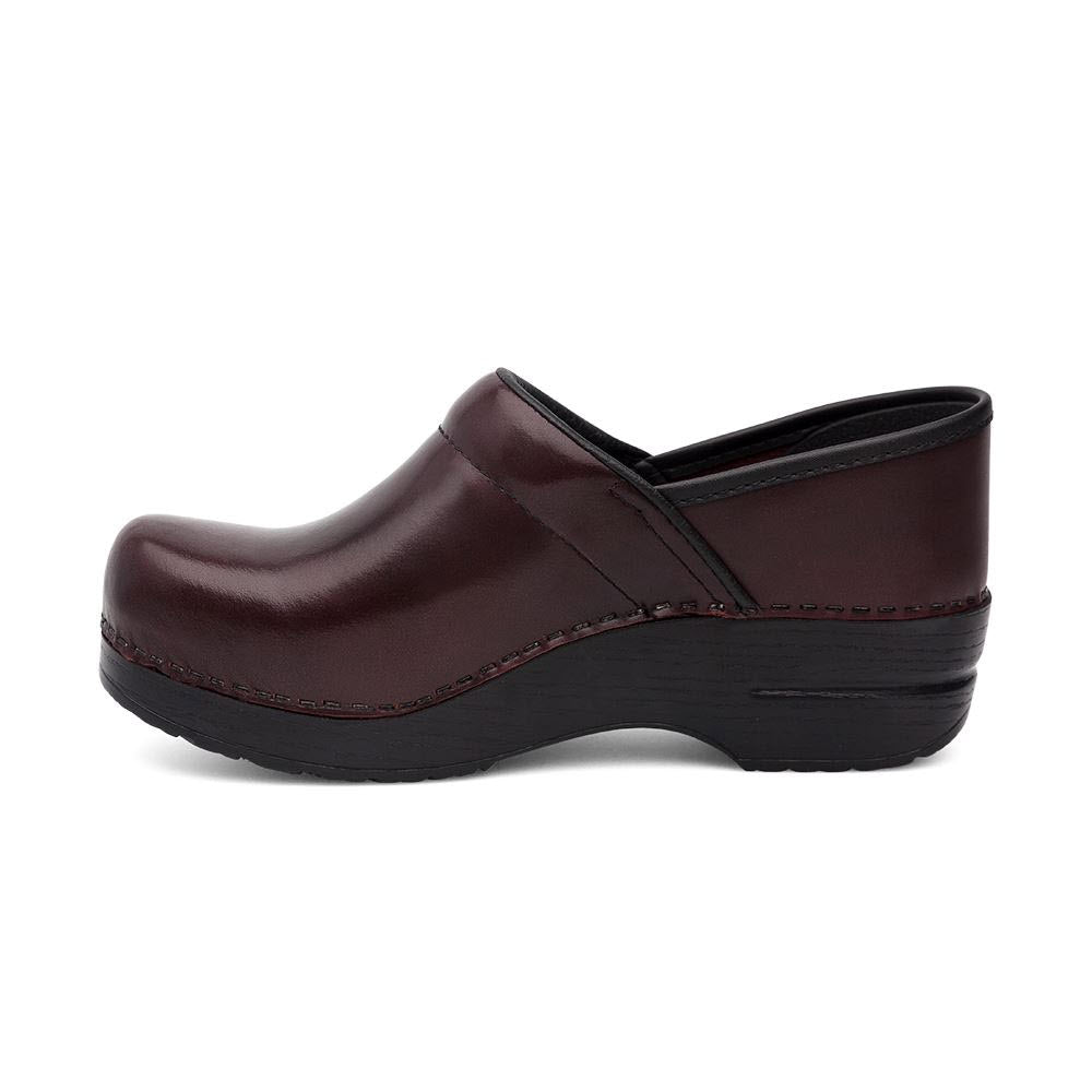 A single DANSKO PROFESSIONAL CORDOVAN CABRIO clog on a white background, featuring a low heel and black outsole.