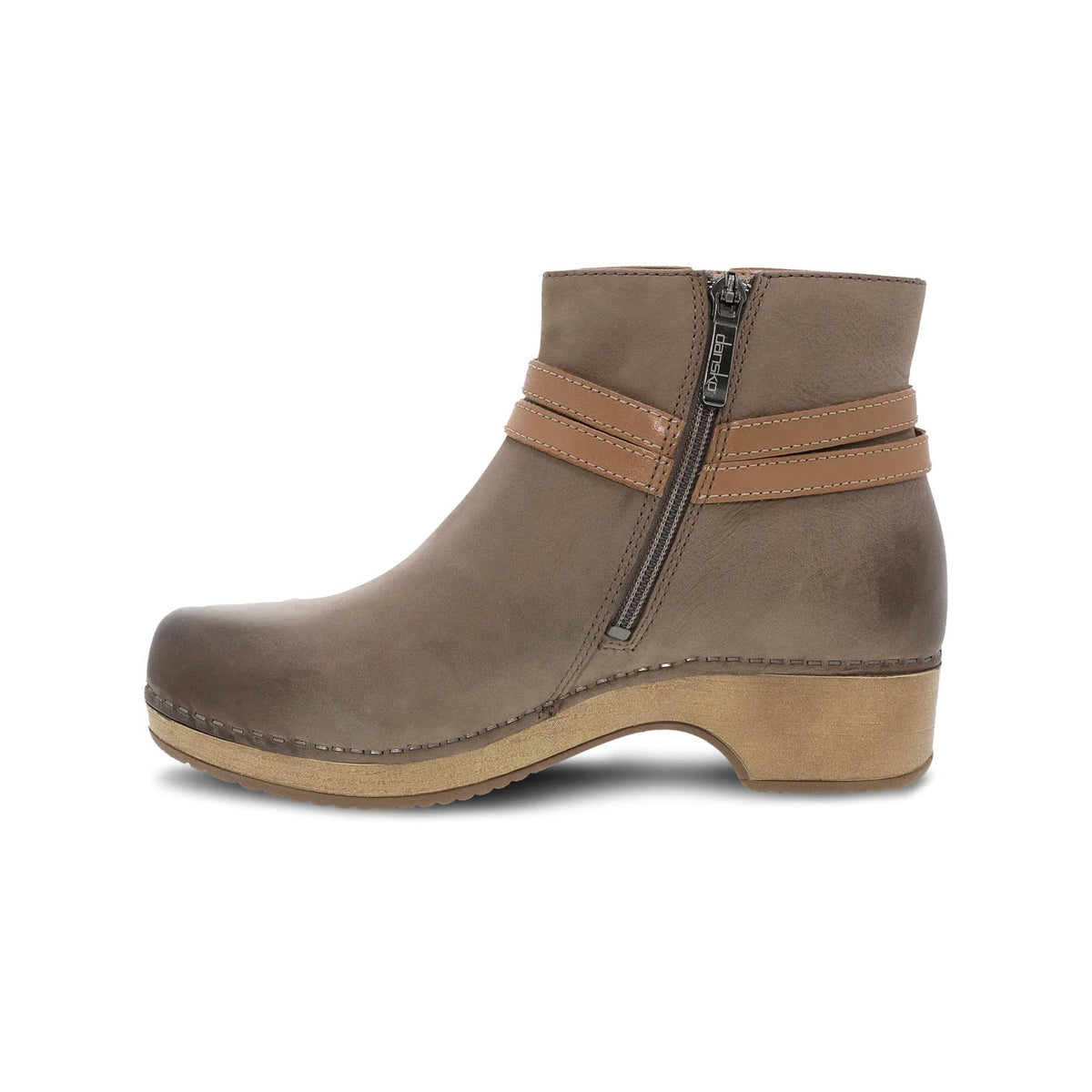A single Dansko Brook Taupe Burnished ankle bootie with a zipper, decorative stitching, and a wooden heel, isolated on a white background.