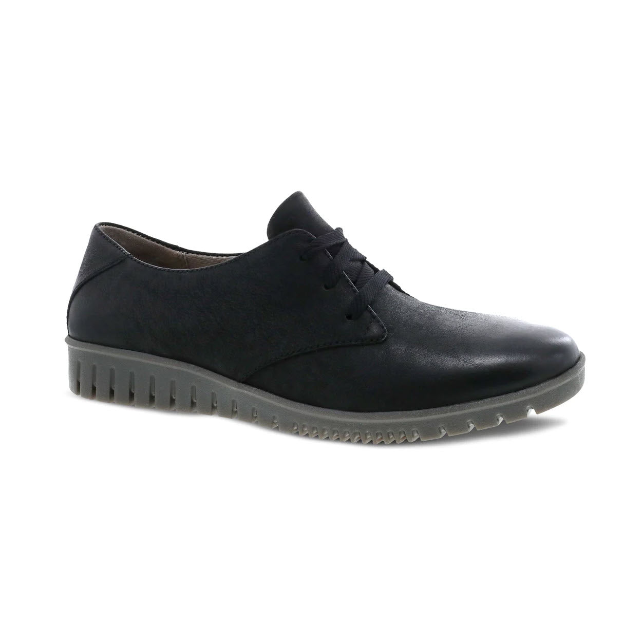 A Dansko Libbie black burnished Oxford shoe with laces and a distinctive ridged sole, isolated on a white background.