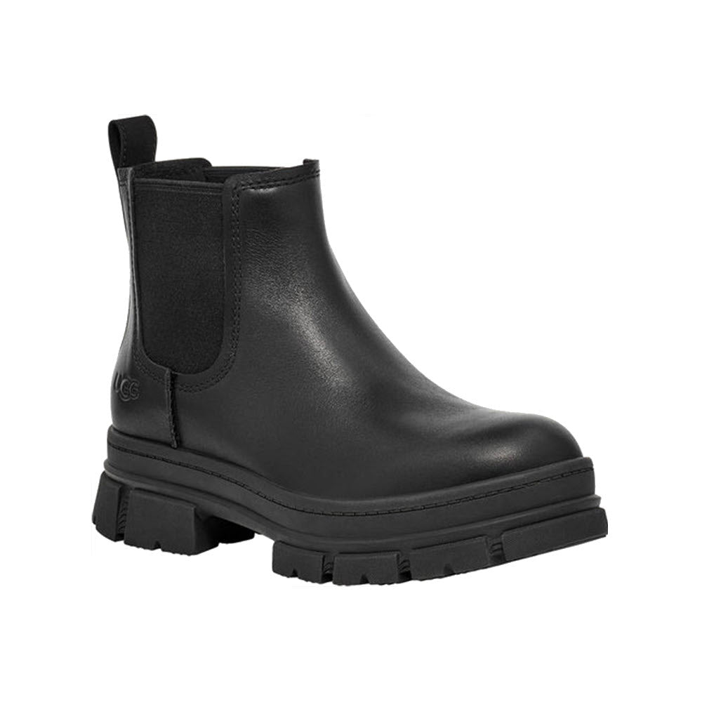 Black full-grain leather UGG ASHTON CHELSEA boot with thick rubber sole and pull tab on a white background.