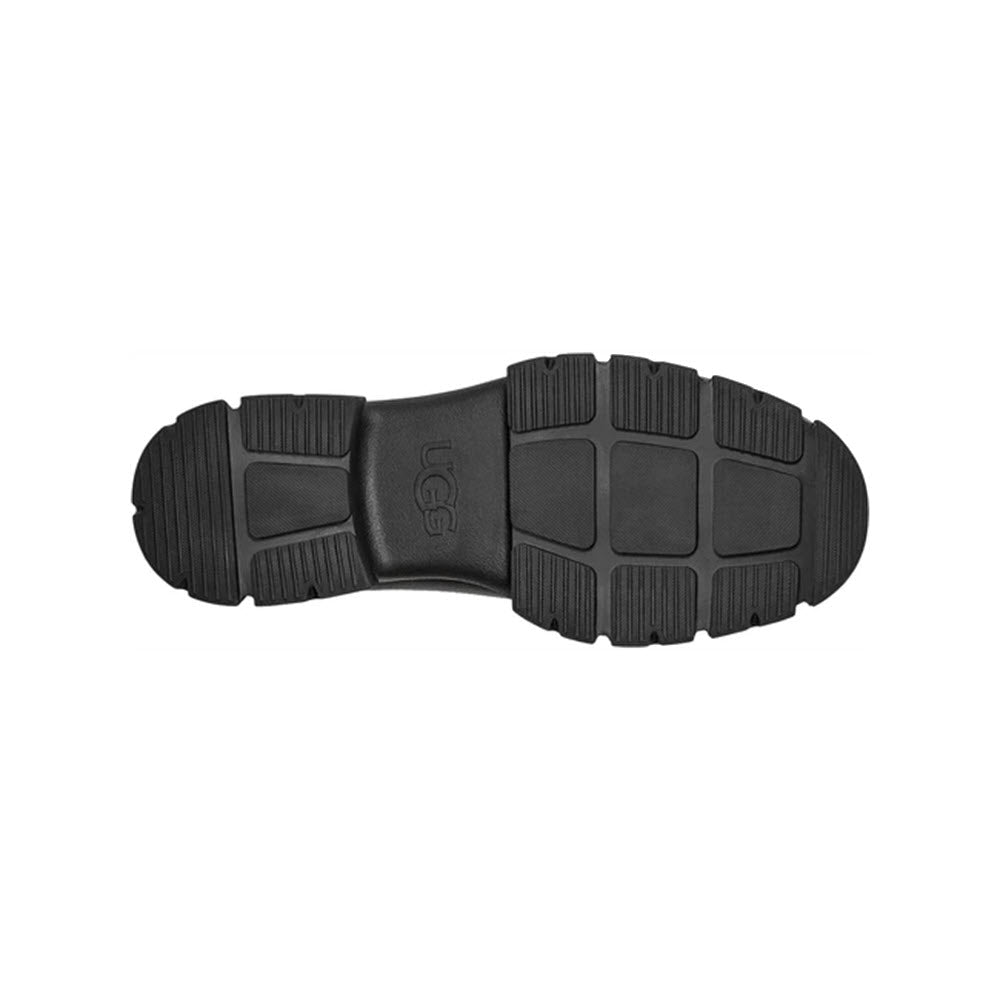 Bottom view of a black waterproof UGG ASHTON CHELSEA boot sole showing tread pattern and brand logo.