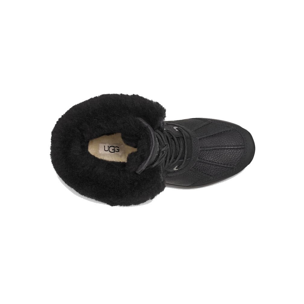 A pair of UGG Adirondack Boot III Black/Black - Womens with laces, viewed from above, with one boot laying on its side showing the furry interior.