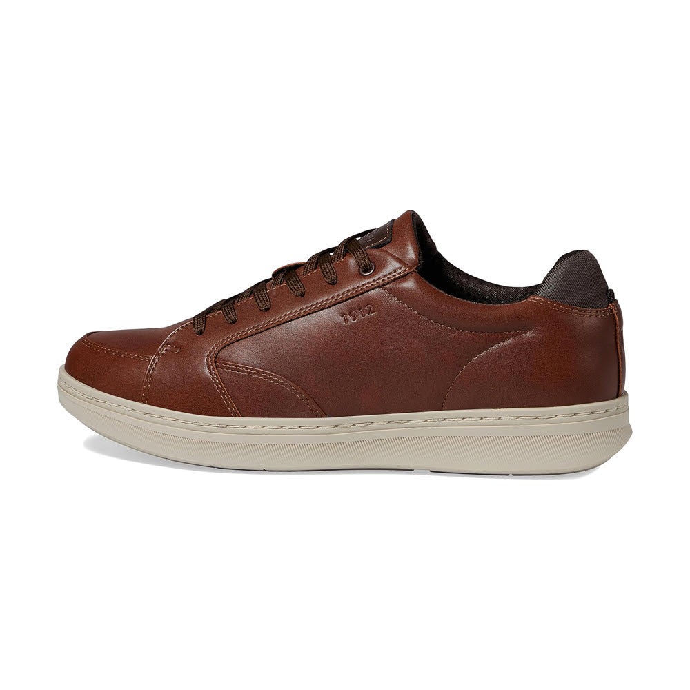 A brown leather Nunn Bush® Aspire Moc Toe Lace Oxford in Cognac Multi for men with white soles, displaying a side view on a white background.