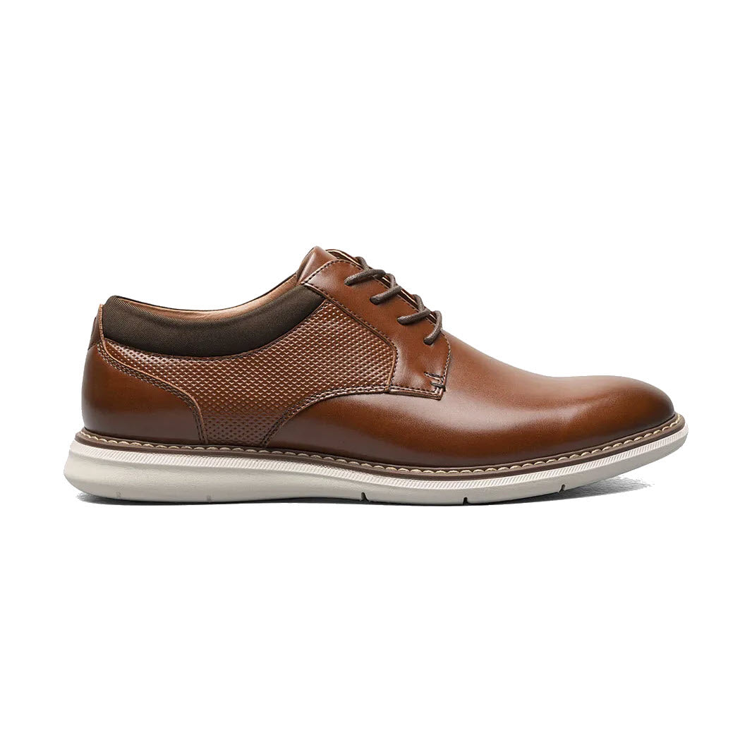 A cognac multi Nunn Bush Chase Plain Toe Oxford with a white sole, lace-up front, and textured side panels, isolated on a white background.