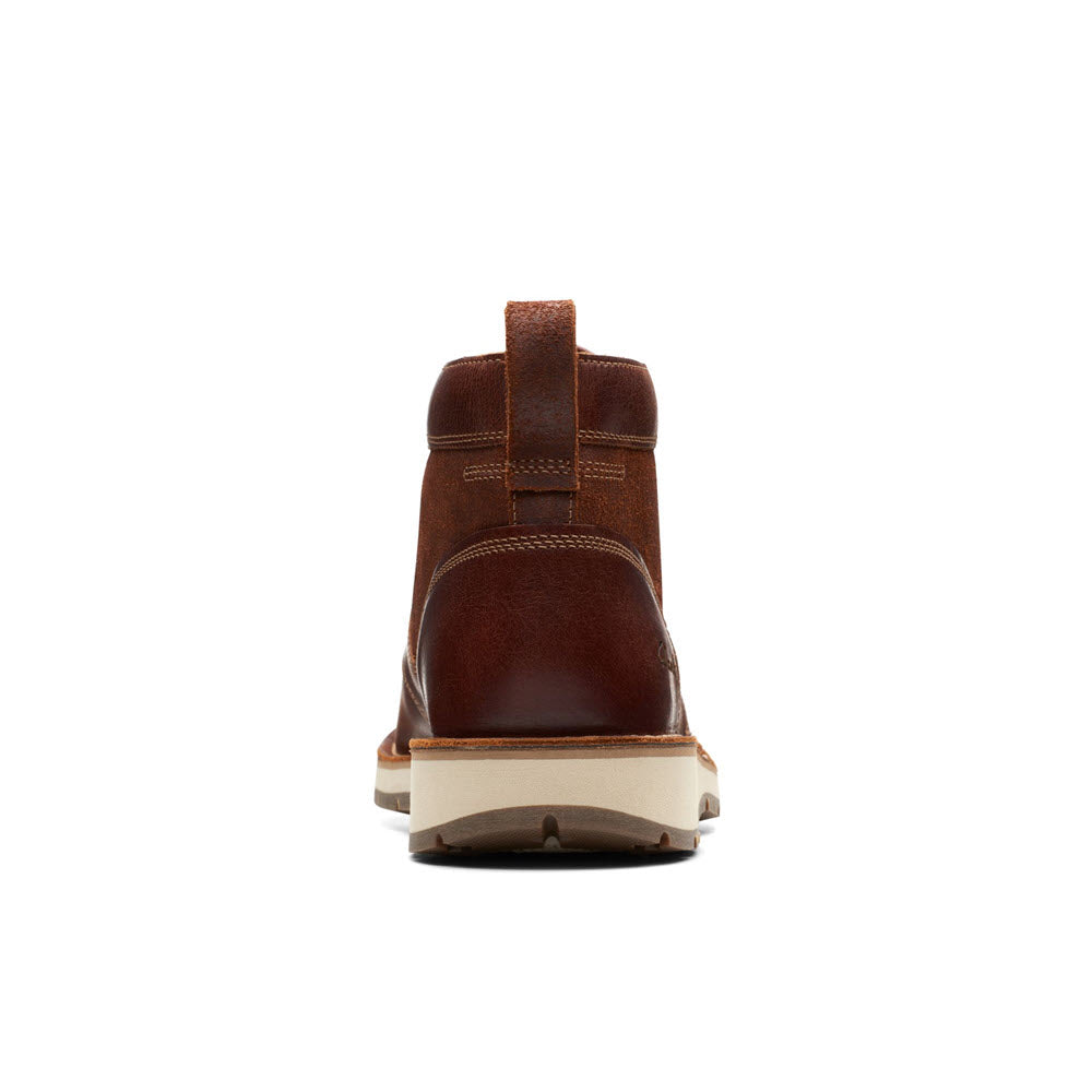 Rear view of a single Clarks Gravelle Top tan leather boot with a white sole, isolated on a white background.