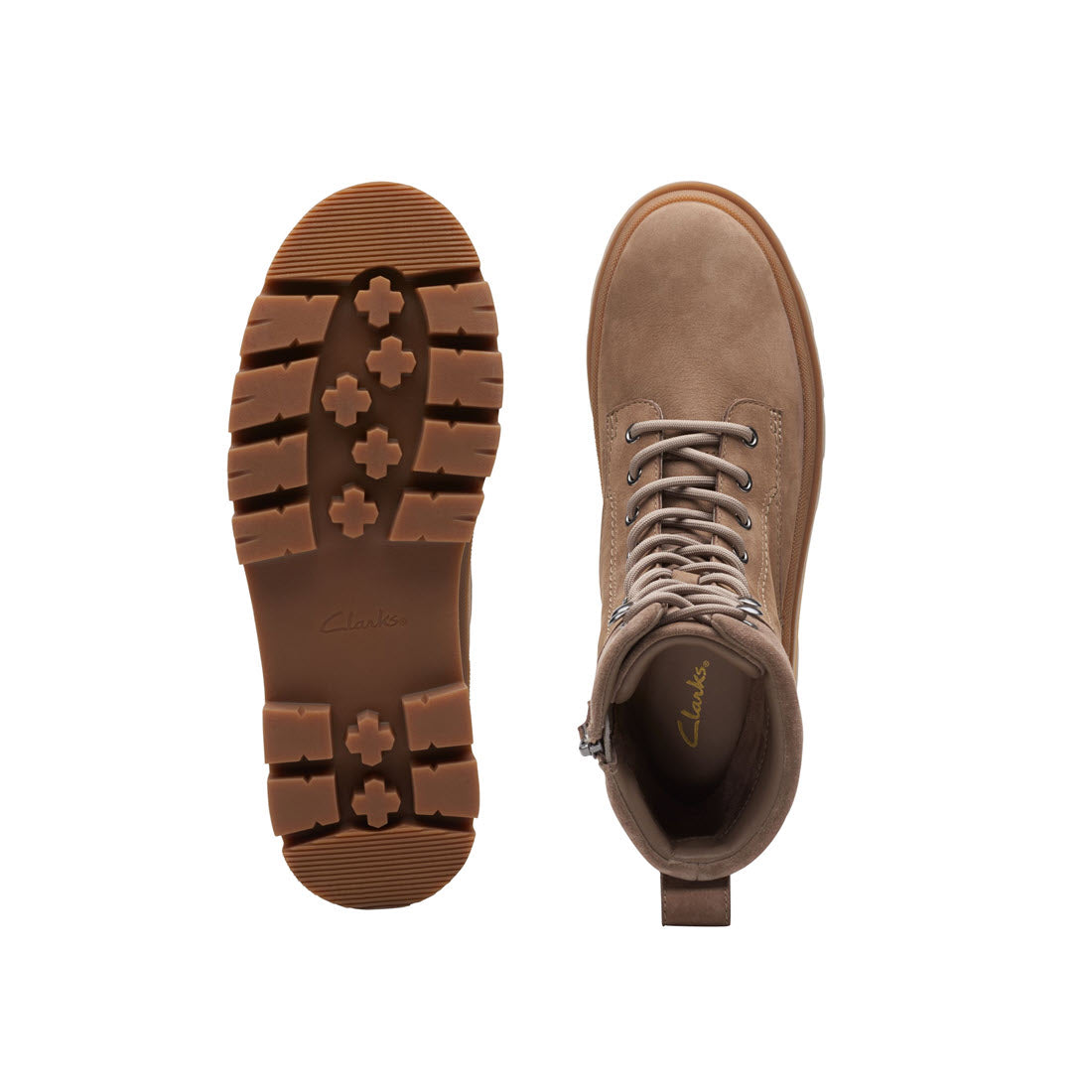 A pair of Clarks Orinna 2 Hike Pebble boots shown from the top and sole view, one upright and the other leaning on its side, featuring a chunky lugged sole, against a white background.