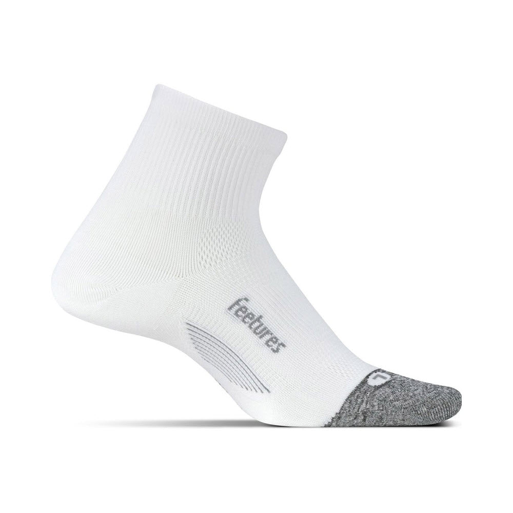 Single white Feetures Elite Ultra Light Quarter Sock with gray accents on the toe and heel, featuring Targeted Compression and the brand name "Feetures" printed along the side, displayed against a white background.