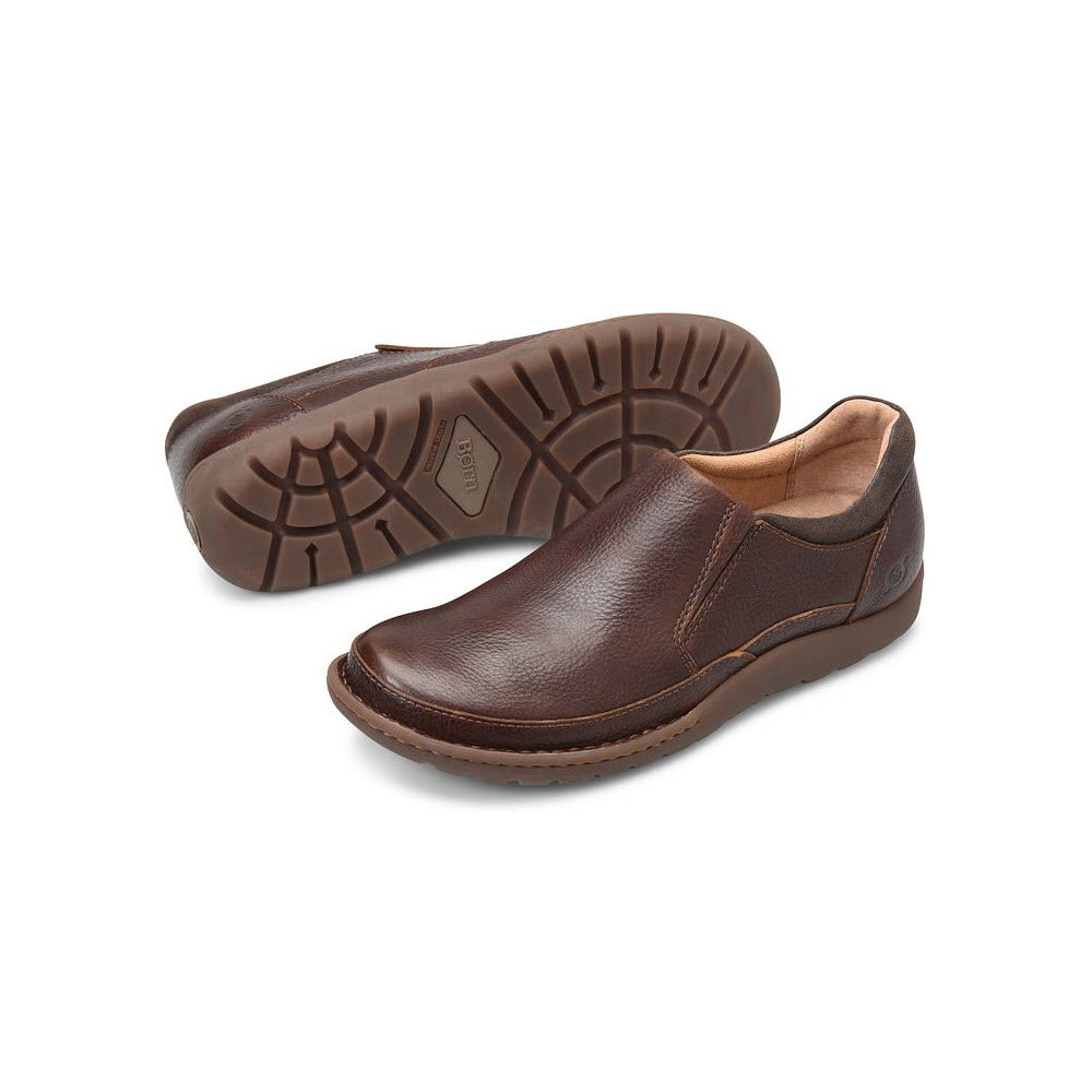 A pair of brown high-quality leather Born Nigel Slip-On shoes with visible stitching and a rubber sole, displayed on a white background.