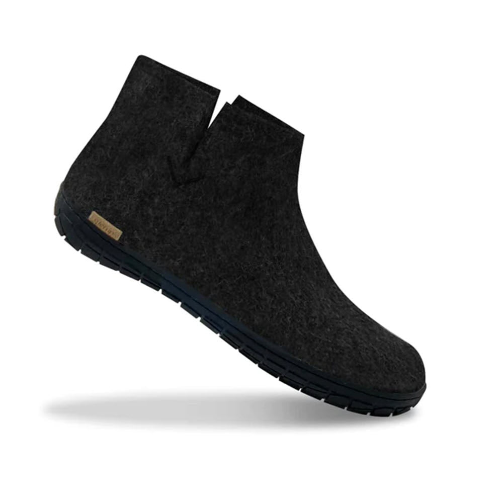Sentence with replaced product: Black felt ankle boot with a minimalistic design and a blue sole, displayed on a white background. Made from natural wool. Glerups The Boot Rubber Charcoal - Adults.