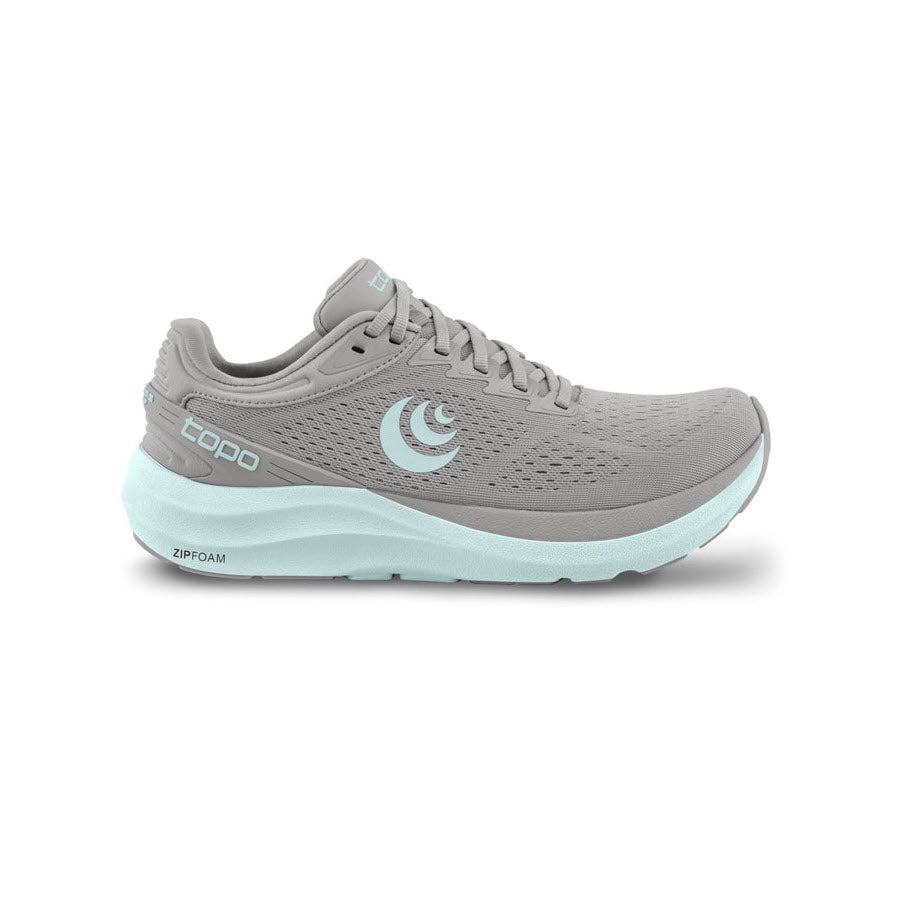 A single TOPO PHANTOM 3 GREY/STONE - WOMENS running shoe with a light blue sole and the logo on the side, displayed against a white background. This daily trainer offers cushioning comfort for all-day wear. (Brand Name: Topo Designs)