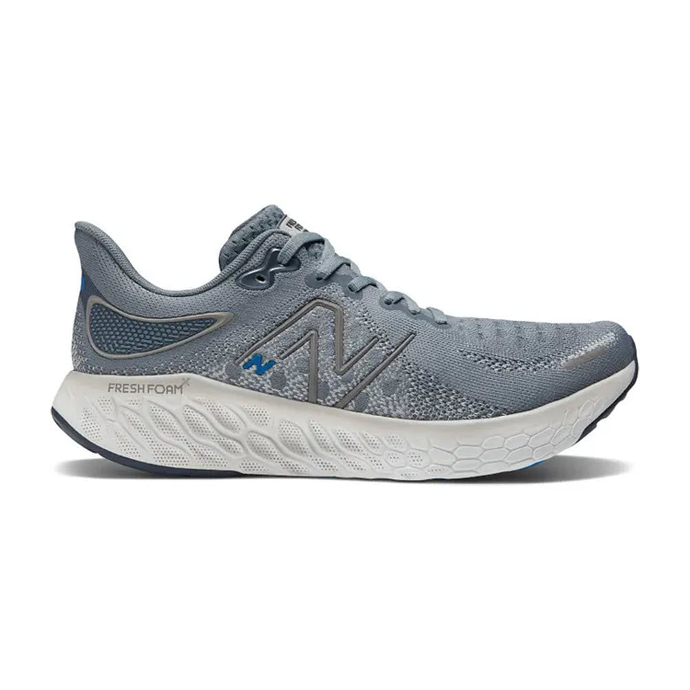 A side view of a gray New Balance M1080v12 Steel/Serene running shoe featuring a prominent logo and &quot;Fresh Foam X 1080v12&quot; text on a white sole.