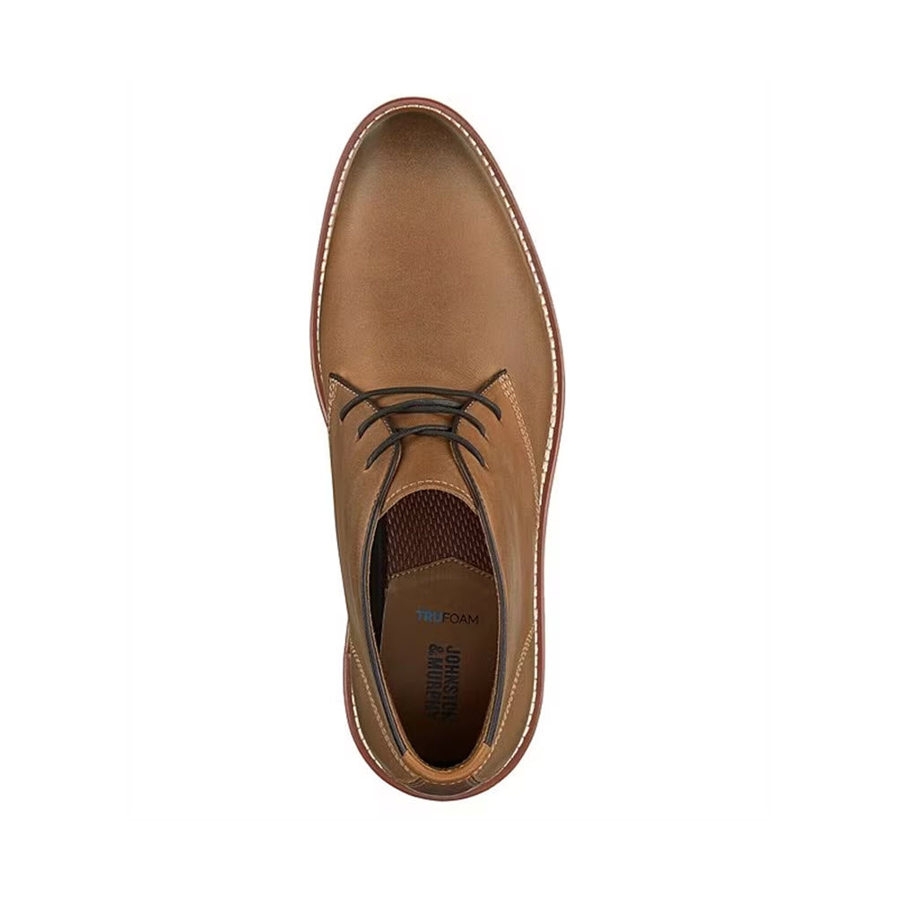 Top view of a Johnston &amp; Murphy Upton Chukka Tan boot with dark brown laces on a white background.