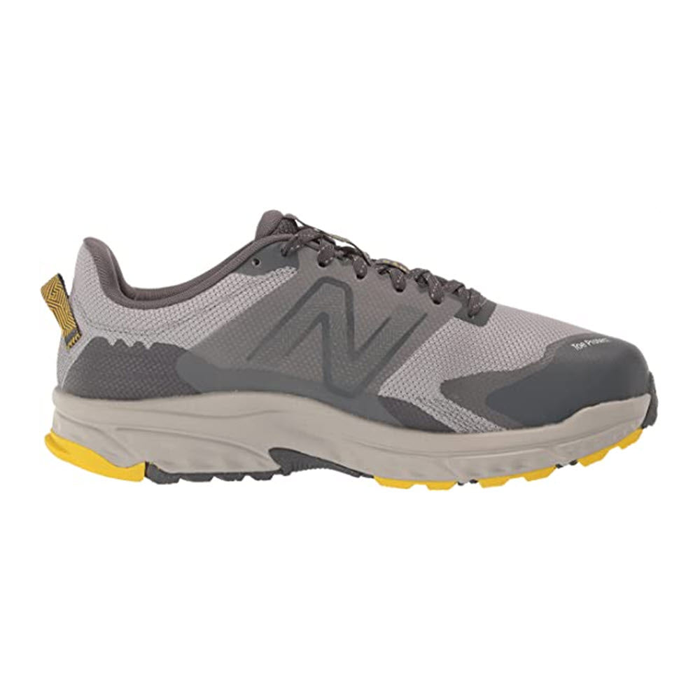 A new New Balance 510V6 Rain Cloud trail running shoe in gray and yellow with a prominent &#39;n&#39; logo on the side.