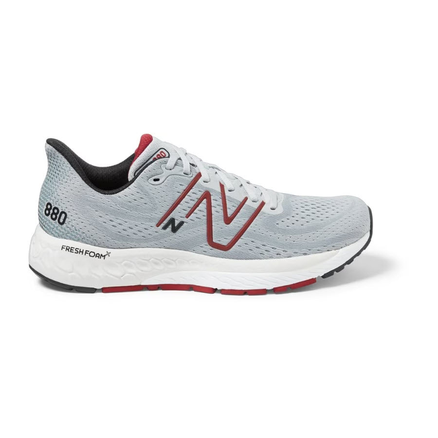 A single New Balance Fresh Foam X 880v13 running shoe from the NEW BALANCE 880V13 GREY - MENS line, with a light gray upper and white sole, featuring a red logo on the side.