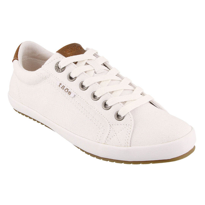 Taos white canvas sneaker with lace-up front, brown leather trim on the heel, and white rubber sole, isolated on a white background.