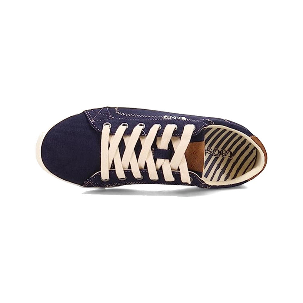Top view of a Taos Star Burst Navy sneaker with white laces and fabricated leather interior.