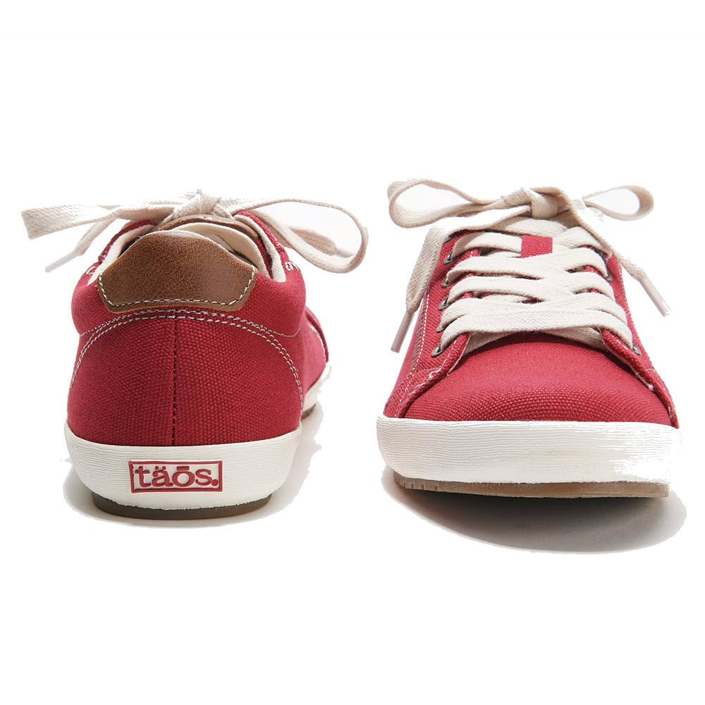 A pair of Taos STAR BURST RED sneakers with white laces and fabricated leather trim, facing each other on a white background.