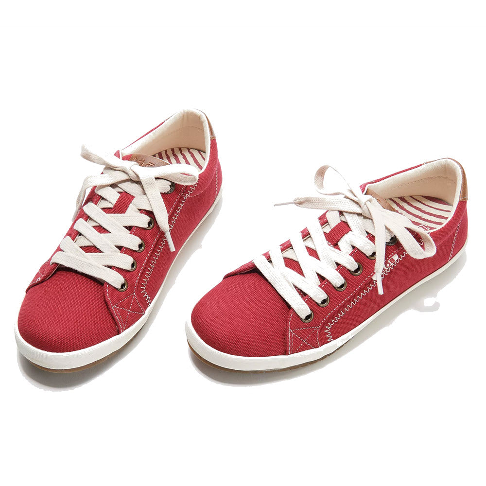 A pair of Taos Star Burst Red - Womens canvas sneakers with white lacing, stitching, and rubber soles, displayed on a white background.