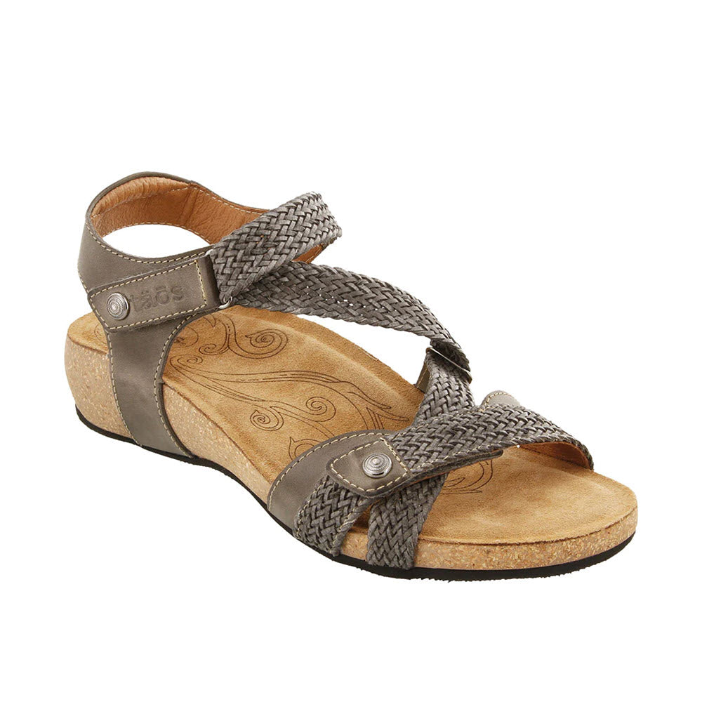 A single Taos TRULIE Dark Grey leather sandal with braided straps and a floral design on the insole.