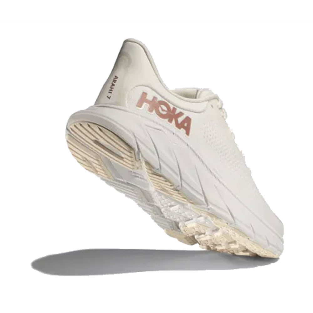 A single white Hoka Arahi 7 stability shoe with its sole visible, floating above a white background casting a slight shadow.