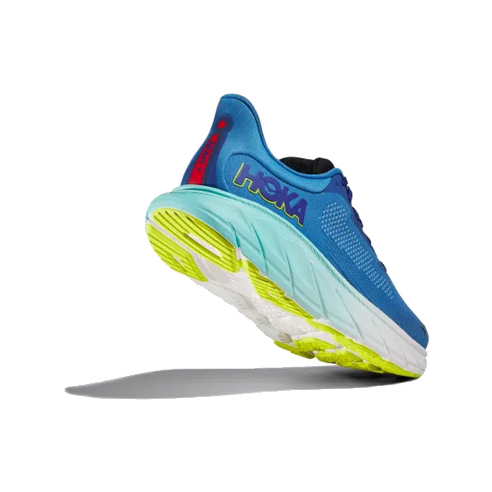 A single Hoka Arahi 7 Virtual Blue/Cerise running shoe angled to show the sole, featuring a vibrant blue upper with lime accents and the brand name &quot;Hoka&quot; displayed.