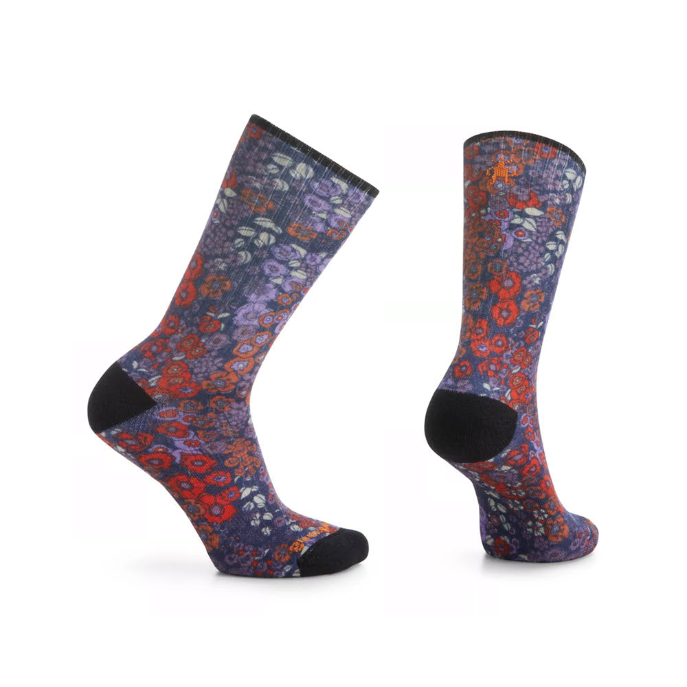 A pair of Smartwool Athletic Crew Socks Meadow Print Navy - Womens displayed against a white background, one sock standing upright and the other tilted.