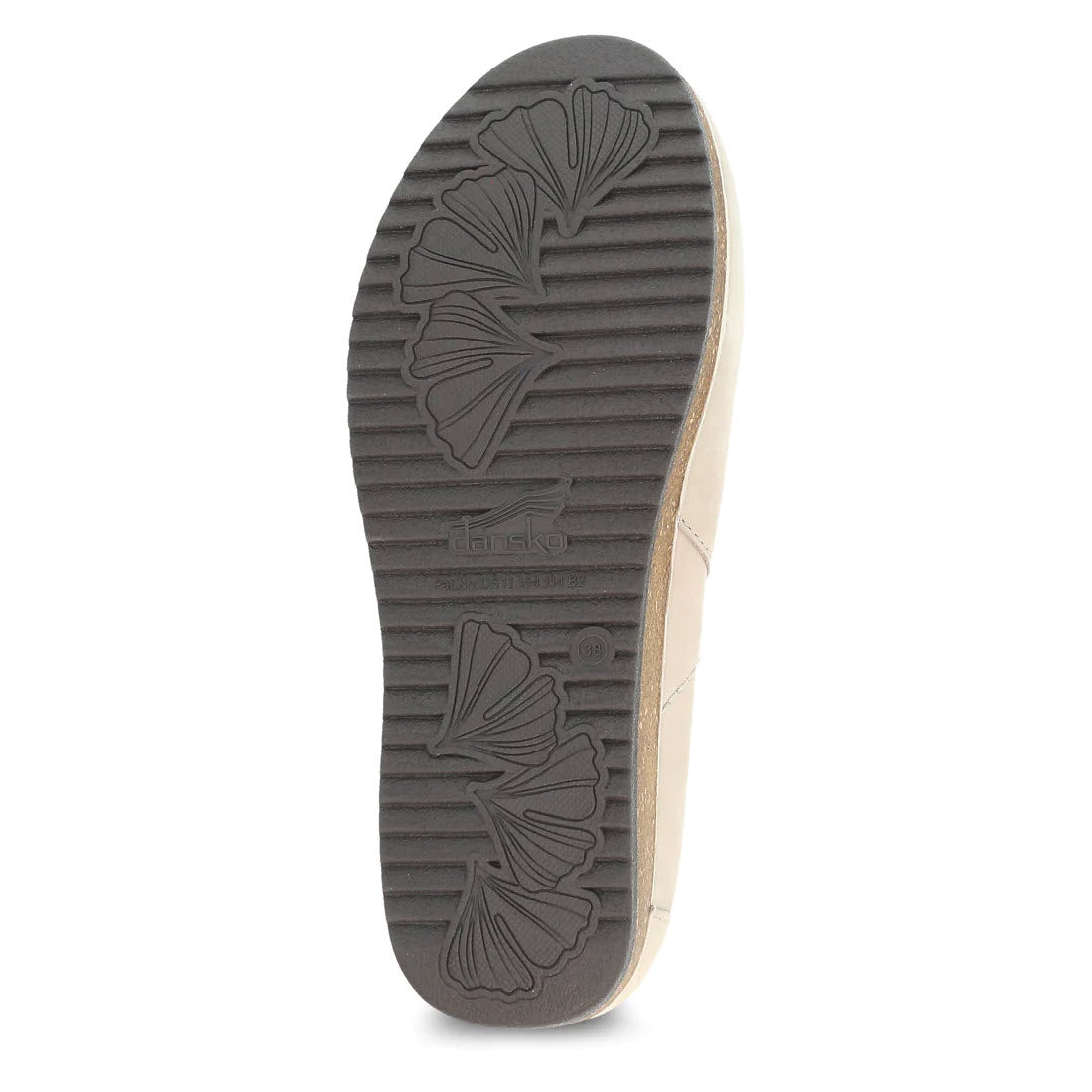 Sole of a tan open back clog displaying a floral pattern and ridged texture for support, with the brand name &quot;Dansko&quot; visible.