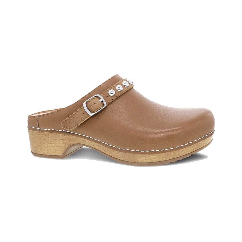 A Dansko Britton Tan womens clog with silver hardware and decorative studs on a white background.