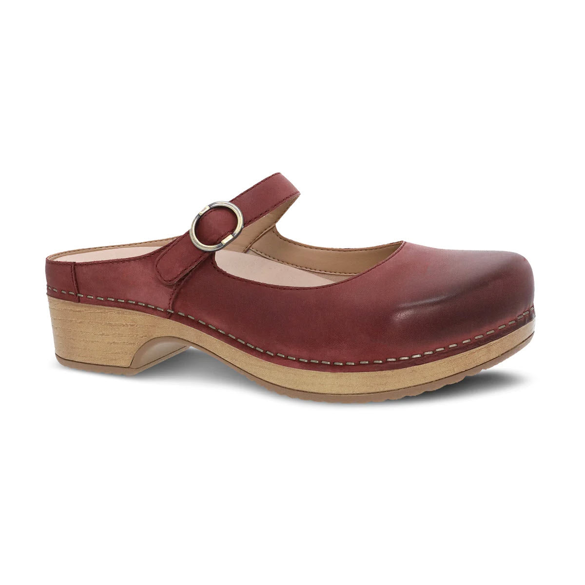 A single red leather Dansko Bria Cinnabar Mary Jane clog with an ankle strap and a wooden heel, isolated on a white background.