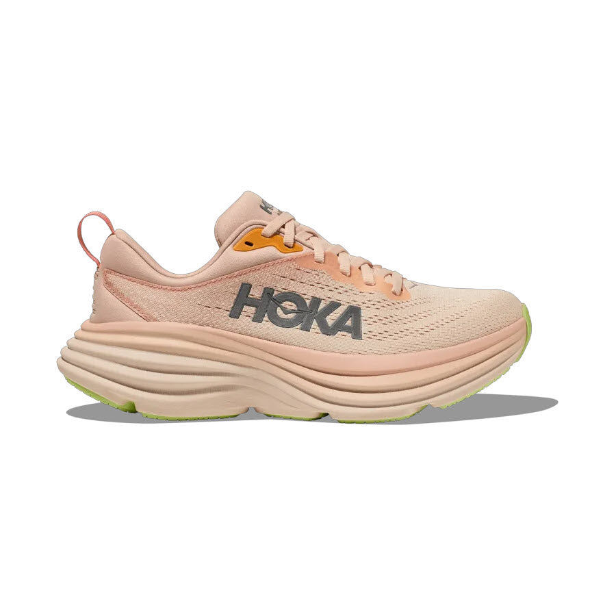 A side view of a peach-colored Hoka Bondi 8 Cream/Vanilla running shoe with ultra-cushioned soles.