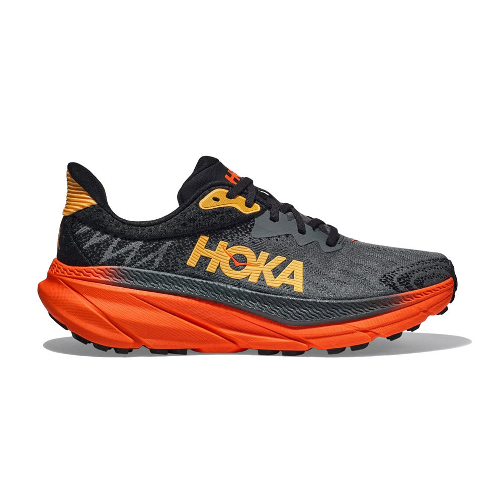 A gray and orange HOKA Challenger ATR 7 trail running shoe with prominent branding on the side and a thick sole.