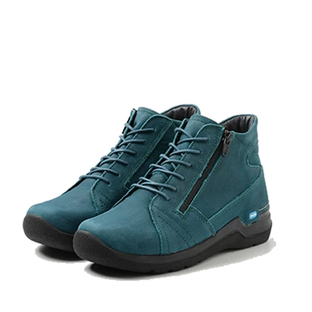 A pair of Wolky teal blue ankle-high lace-up sneakers with laces, set against a white background.