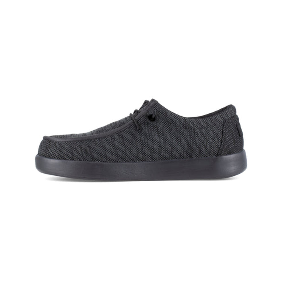 Side view of a single Volcom Chill Composite Toe Slip On Work Shoe Black - Mens with laces and slip-resistant soles, isolated on a white background.