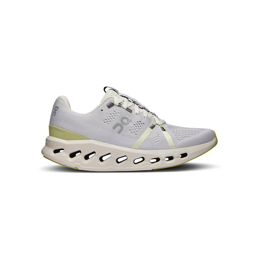 Profile view of a ON RUNNING CLOUDSURFER WHITE/SAND - WOMENS athletic sneaker with white laces, featuring CloudTec cushioning and subtle yellow accents.