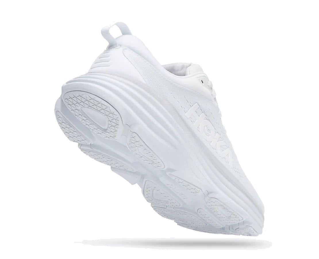 A single white HOKA BONDI 8 WHITE/WHITE - WOMENS sneaker tilted to show its side and sole against a white background.