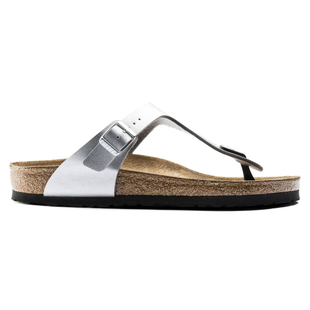 Single white strap Birkenstock Gizeh Silver sandal with buckle detail and cork footbed, isolated on white background.
